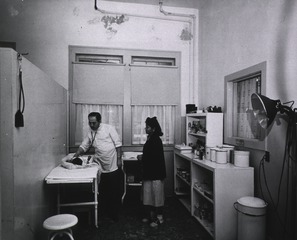 Albuquerque General Hospital: Dr. H.K. Bobroff, Senior Medical Officer, examines a young patient in the Out-patient clinic