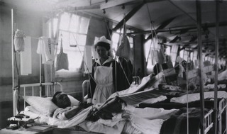 U. S. Army Hospital Center, Beau Desert, France: A wounded soldier in bed, showing a Balkan frame