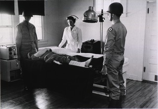 U.S. Army, Fitzsimons General Hospital, Denver, CO: Two soldiers carry a patient on a stretcher to a physical therapist