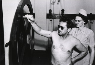 U.S. Army, Valley Forge Army Hospital, Phoenixville, Pennsylvania: Patient, under supervision, exercises his shoulder on wheel after loss of muscle