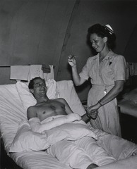 U.S. Naval Hospital, Guam: Nurse taking patient's pulse and temperature