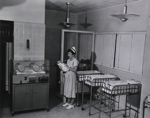 U.S. Naval Hospital, Beaufort, SC: Nurse with baby in nursery