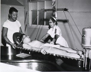 U.S. Naval Hospital, Oakland, CA: Paraplegic patient lowered into Hubbard Tank for physical therapy