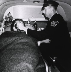 West Hudson Hospital, Kearny, N.J: Interior view- Ambulance, showing attendant with patient