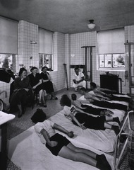 Dr. W.H. Groves Latter-Day Saints Hospital, Salt Lake City, UT: Physiotherapist giving directions to convalescent poliomyelitis patients with mothers watching