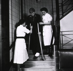Middlesex Hospital, London, England: Patient descending stairs on cruches