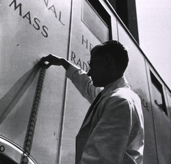Middlesex Hospital, London, England: Radiographer of mobile unit examining x-ray film