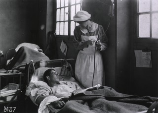 U.S. American National Red Cross Hospital No.1, Paris, France: Wounded soldier being attended to by Red Cross Nurse