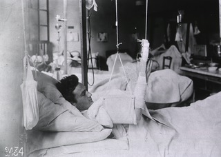 U.S. American National Red Cross Hospital No.1, Paris, France: Wounded American soldier reading newspaper