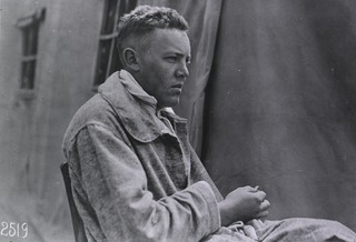 U.S. American National Red Cross Hospital No. 5, Auteuil, France: Convalescent soldier sitting outside of a hospital tent