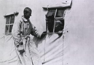 U.S. American National Red Cross Hospital No. 5, Auteuil, France: Two patients talking through a window in one of the hospital tents