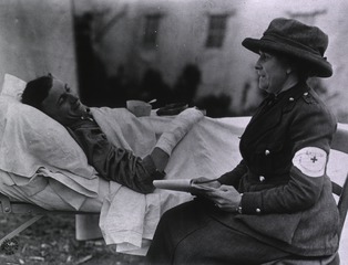 U.S. American National Red Cross Hospital No. 5, Auteuil, France: A Red Cross Nurse writing letters for a wounded soldier