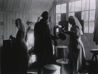 U.S. American National Red Cross Evacuation Hospital No. 114, Fleury-sur-Aisne, France: Nurses in canteen serving hot chocolate to patient