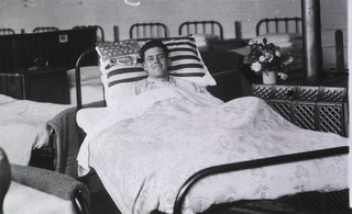 Great Britain, British Red Cross Society Voluntary Aid Detachment Hospital, Newton-Abbot, England: Smiling patient in bed