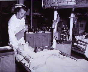 USS Repose (Hospital Ship): Interior view- Medical Ward, Nurse caring for blast victims