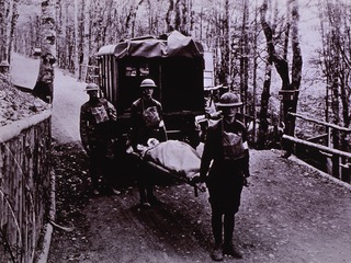 Ambulances: Rear view of ambulance with attendants and wounded