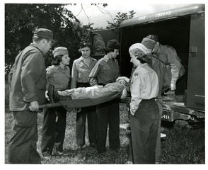 Transportation of wounded and sick: Wounded soldier loaded into an ambulance