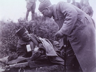 U.S. American National Red Cross: Capt. G.E. West ARC, talking to wounded. [Argonne Forest, France]