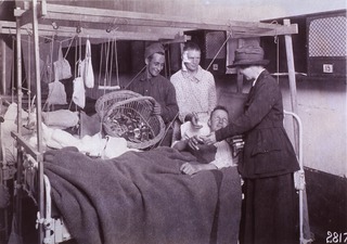 U.S. American National Red Cross: ARC canteen workers distribute tobacco to wounded soldiers. (note Balkan Frames)