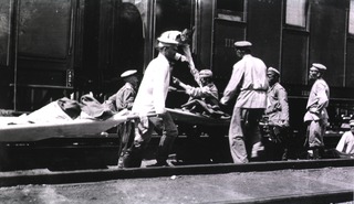 [Loading typhoid patients onto a hospital train, Station 83, Manchuria]