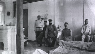 [The Commanding Surgeon of Military Mobile Hospital No. 84, Gungalin, sitting in a ward]