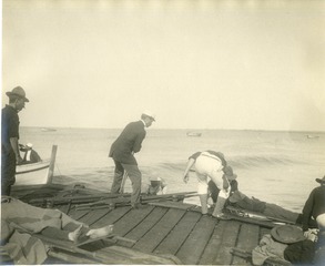 [Loading sick on boats for transfer to H.S. Relief at Arroya, Puerto Rico]
