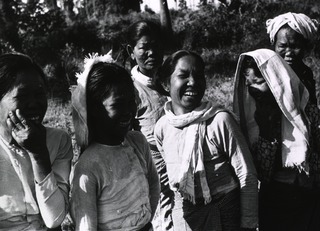 [Appreciative spectators during entertainment and dancing in a leper colony]