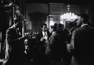 A group of young European males engaged in a drinking bout