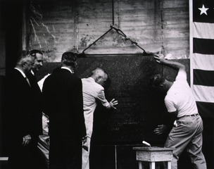 [President Truman assists construction worker in placing the corner stone during Clinical Center dedication ceremonies]