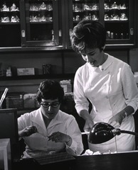 [Two female medical technicians prepare throat cultures in Clinical Pathology Department]