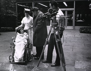 [A Clinical Center patient is briefed by a television director before filming]