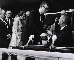 [President Lyndon Johnson greets James A. Shannon at the ceremony for the signing of the Health Research Facilities Act]