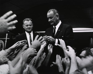 [President Lyndon Johnson signing autographs at the ceremony for the signing of the Health Research Facilities Act]