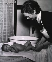 [Nurse bathing a baby]