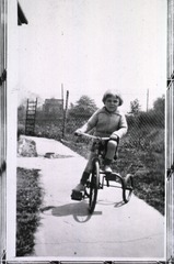[Child on a tricycle]