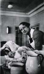 [Mrs. Latham teaches the mothers how to bathe the baby.]
