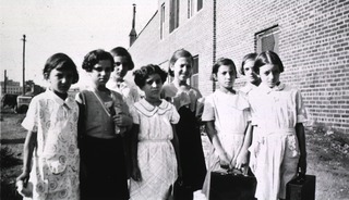 [A group of girls headed for Camp Fire Day Camp]