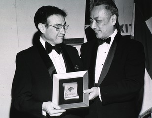 [Dr. Theodore Cooper receives the Gold Heart Award, presented by Dr. Paul N. Yu]