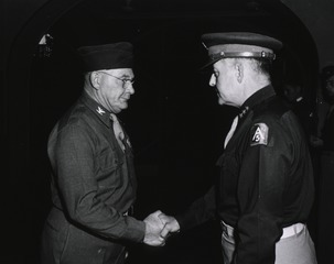 Colonel Clifford E. Pickering, surgeon, U.S. Fifth Army, of San Francisco, Calif., left, is congratulated by Lt. Gen. Lucian K. Truscott, Jr., CG, U.S. Fifth Army, after presenting him with the Bronze Star Medal
