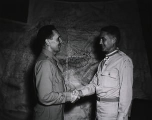 Colonel Earle Standlee, Chief Surgeon, Mediterranean Theater of Operations, U.S. Army, congratulates Col. Hugh R. Gilmore, Jr. of Emlenton, Pa., after he received the decoration of Knight Commander, Order of the Crown of Italy, Caserta, Italy, 9/20/[19]45
