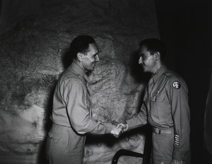 Colonel Earle Standlee, Chief Surgeon, MTOUSA, congratulates Maj. Daniel J. Holland, Boston, Mass., after presenting him with the Bronze Star Medal for meritorious achievement in connection with military operations, Caserta, Italy, 9/20/[19]45