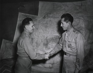 Colonel Earle Standlee, Chief Surgeon, MTOUSA, congratulates Maj. Thomas H. Buford, Mokan, Mo., after presenting him with the Legion of Merit