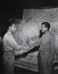 [Colonel Albert A. Biederman congratulates Col. Martin Griffin, Washington, D.C., of the Medical Corps, after awarding him the Legion of Merit for outstanding service with military operations in Italy, Caserta, Italy, 14 September 1945]