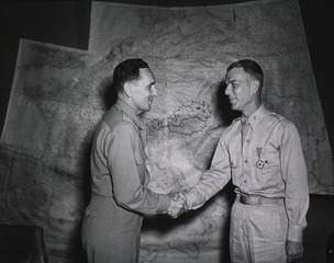 Colonel Earle Standlee, Chief Surgeon, MTOUSA, congratulates Lt. Col. George M. Duncan, 816 Gates Ave., Norfolk, Va., after presenting him with the Legion of Merit
