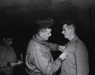 Brigadier General Joseph I. Martin, Chief Surgeon, Fifth Army, presents the Legion of Merit to Maj. James M. Mason, Birmingham, Ala., of the 32nd Field Hospital, for outstanding services in Sicily and Italy, Italy, 8 November 1944
