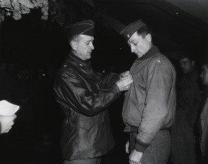Brigadier General Joseph I. Martin, Fifth Army Surgeon, pins the Legion of Merit on Lt. Col. Harris S. Holmboe, 308 Park Place, Charlottesville, Va., of the 8th Evacuation Hospital, Italy, 16 January 1945