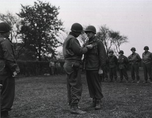 Chaplain (Capt.) Edgar H. Stohler, Ipava, Ill., receives the Silver Star for gallantry in action in France from Brig. Gen. James A. Van Vleet, commandant of the 90th Infantry Division