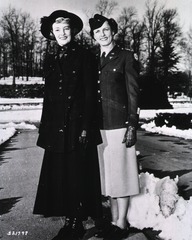Captain Mary Cotterell, Army Nurse Corps, modelling World War I nurses' uniform, and 1st Lt. Margaret Peters, ANC, modelling the present day uniform