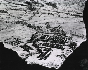 [Bird's-eye view of the 8th Evacuation Hospital and snow-covered countryside from a nearby mountain]