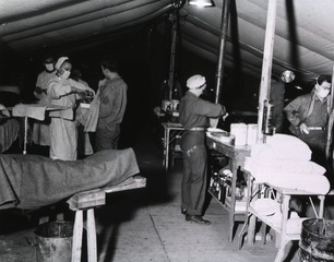 Nurses and doctors at work in surgery room of the 94th Evacuation Hospital, Le Pezzia area, Italy
